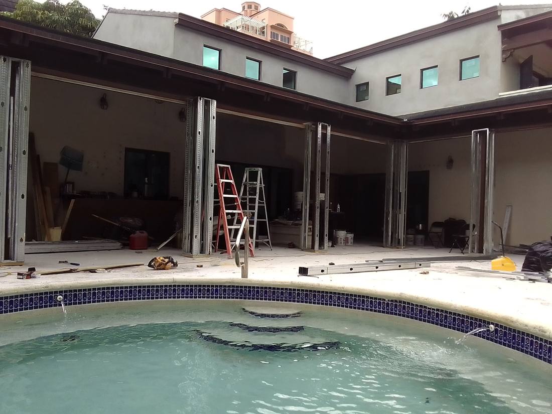 Pool house with folding glass walls