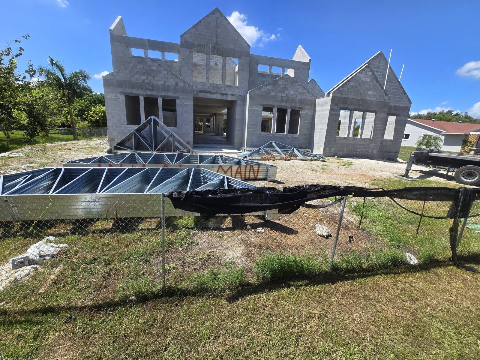 Two-story block home with trusses going up